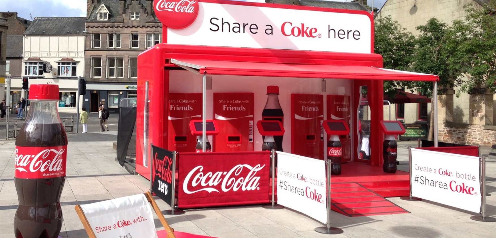 The “Share a Coke” campaign went on tour so people in selected cities around the world could personalize a bottle of Coke at the sharing stations. title=
